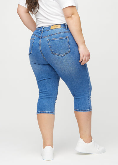 Denim skinny capris set bagfra på en plus-size model, så man kan se hele produktet.